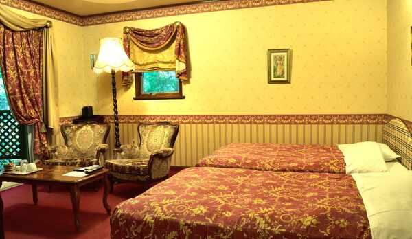 110号室の入口付近から見たベッドとリラックススペースです